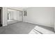 A spacious bedroom with a mirrored closet door, a window, and neutral carpet at 12115 Bannock St # B, Denver, CO 80234