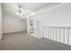 Bright open bonus room featuring high ceilings with a fan, neutral walls, and soft carpet at 12115 Bannock St # B, Denver, CO 80234