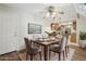 Elegant dining area with a modern ceiling fan, a cityscape art piece, and access to kitchen at 12115 Bannock St # B, Denver, CO 80234