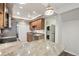 Contemporary kitchen with granite countertops, stainless appliances, and adjacent laundry area at 12115 Bannock St # B, Denver, CO 80234