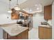 Modern kitchen featuring granite countertops, stainless steel appliances, and tile flooring at 12115 Bannock St # B, Denver, CO 80234