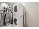 Laundry room area with a stacked washer and dryer and utility connections at 12115 Bannock St # B, Denver, CO 80234