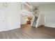 Spacious living area with staircase, wood floors, and access to a partial view of the kitchen at 12115 Bannock St # B, Denver, CO 80234