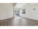Bright living room features hardwood floors, a sliding glass door, and a white interior door at 12115 Bannock St # B, Denver, CO 80234