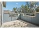 Enclosed patio with concrete floor, privacy walls, and views of the surrounding trees at 12115 Bannock St # B, Denver, CO 80234