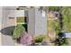 An aerial perspective of the home showcases its roof and manicured front lawn, enhanced with blooming trees and a welcoming walkway at 6103 Uno St, Arvada, CO 80003