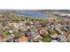 Aerial view of the community with a large lake, lush trees, and a cityscape in the distance at 6103 Uno St, Arvada, CO 80003