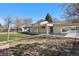 Large fenced backyard with a covered patio and an open carport area at 6103 Uno St, Arvada, CO 80003