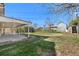 Backyard with a covered patio, shed, chain link fence, and mature plants at 6103 Uno St, Arvada, CO 80003