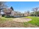A grassy backyard features mature trees, a covered patio, and plenty of open space at 6103 Uno St, Arvada, CO 80003