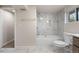 This newly renovated bathroom features modern tile, a soaking tub, and new fixtures at 6103 Uno St, Arvada, CO 80003