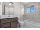 Updated bathroom featuring a marble tile shower and newer vanity at 6103 Uno St, Arvada, CO 80003