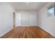 Bedroom featuring hardwood floors, fresh paint, closet with double doors and ample natural light at 6103 Uno St, Arvada, CO 80003