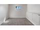 This bedroom features neutral walls, carpet flooring, a window, and a storage area at 6103 Uno St, Arvada, CO 80003