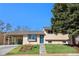 Inviting home with a well-maintained lawn, tasteful landscaping, and a covered carport at 6103 Uno St, Arvada, CO 80003