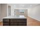 Updated kitchen features a convenient kitchen island, stainless appliances, and plenty of light at 6103 Uno St, Arvada, CO 80003