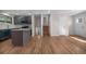 An empty kitchen view shows a convenient kitchen island, modern grey cabinetry, and stainless appliances at 6103 Uno St, Arvada, CO 80003