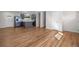 Bright living room features beautiful hardwood floors, stainless appliances, and open floorplan at 6103 Uno St, Arvada, CO 80003
