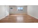 A spacious empty room view shows beautiful hardwood floors, great natural light, and neutral walls at 6103 Uno St, Arvada, CO 80003