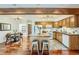 Open kitchen and dining area features an island with seating and ample cabinet space at 1777 S Union Blvd, Lakewood, CO 80228