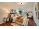 Cozy bedroom featuring hardwood floors, natural light, and stylish decor at 1777 S Union Blvd, Lakewood, CO 80228