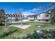 View of a home's backyard with a pergola on a well-maintained lawn under a blue sky at 2781 Savage Rd, Elizabeth, CO 80107