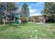 Lush backyard features a playground, swing set, and pergola; perfect space for Gathering enjoyment at 2781 Savage Rd, Elizabeth, CO 80107