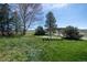 Lush green backyard with pergola-covered patio and mature landscaping at 2781 Savage Rd, Elizabeth, CO 80107