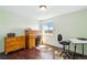 Bedroom with wood floors, an antique roll top desk, wood dresser, and natural light from a window at 2781 Savage Rd, Elizabeth, CO 80107