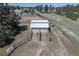 Aerial view of stables showcasing well-maintained structure, green pastures, and functional design at 2781 Savage Rd, Elizabeth, CO 80107