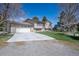 Inviting home with a large driveway, attached garage, and well-maintained front lawn at 2781 Savage Rd, Elizabeth, CO 80107