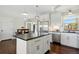 Bright kitchen with white cabinetry, stainless steel appliances, and a breakfast bar island at 2781 Savage Rd, Elizabeth, CO 80107