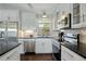 Well-appointed kitchen featuring sleek countertops, white cabinets, and stainless steel appliances at 2781 Savage Rd, Elizabeth, CO 80107