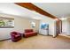 Bright living room with a beamed ceiling, comfortable seating, and plenty of natural light from multiple windows at 2781 Savage Rd, Elizabeth, CO 80107