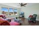 Bright living room with hardwood floors, cozy seating, and expansive windows with scenic views at 2781 Savage Rd, Elizabeth, CO 80107
