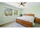 Light and airy main bedroom boasts two windows, a ceiling fan and light green paint at 2781 Savage Rd, Elizabeth, CO 80107