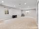 Finished basement featuring neutral carpet, recessed lighting, and egress windows for natural light at 14134 Glenayre Cir, Parker, CO 80134
