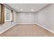 Finished basement featuring neutral carpet, recessed lighting, and an egress window with curtains at 14134 Glenayre Cir, Parker, CO 80134