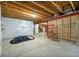 Unfinished basement offering exposed ceiling and utilities and ample storage potential at 14134 Glenayre Cir, Parker, CO 80134