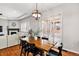 Dining room with fireplace, wood table, chandelier, and outdoor access at 14134 Glenayre Cir, Parker, CO 80134