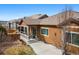 Exterior view featuring a covered patio and manicured backyard of this brown-sided home at 14134 Glenayre Cir, Parker, CO 80134