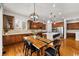 Modern kitchen with a large island, stainless steel appliances, and an adjacent dining space at 14134 Glenayre Cir, Parker, CO 80134