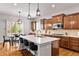 Beautiful kitchen features a large island with seating, stainless steel appliances and modern pendant lighting at 14134 Glenayre Cir, Parker, CO 80134