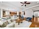 Open-concept living room featuring a sectional sofa, hardwood floors, and a view of the kitchen at 14134 Glenayre Cir, Parker, CO 80134