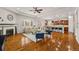 Bright open-concept living room boasts a cozy sectional, fireplace and hardwood floors at 14134 Glenayre Cir, Parker, CO 80134