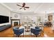 Cozy open-concept living room boasts a fireplace and hardwood floors at 14134 Glenayre Cir, Parker, CO 80134