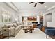 Bright open-concept living room boasts a cozy sectional, ceiling fan, and hardwood floors at 14134 Glenayre Cir, Parker, CO 80134