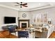 Open-concept living room boasts a fireplace and hardwood floors at 14134 Glenayre Cir, Parker, CO 80134