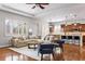 Bright open-concept living room boasts a cozy sectional and hardwood floors at 14134 Glenayre Cir, Parker, CO 80134