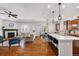 Open living area with a gas fireplace, dining area, and kitchen island at 14134 Glenayre Cir, Parker, CO 80134